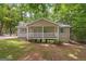 Charming home featuring a cozy front porch with white railings and blue shutters and door at 438 Punkintown Rd, Villa Rica, GA 30180