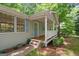 Charming front porch featuring wooden flooring, white railings, and a stylish front door at 438 Punkintown Rd, Villa Rica, GA 30180