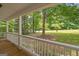 Spacious front porch with wood floors and a view of the lush green lawn at 438 Punkintown Rd, Villa Rica, GA 30180