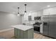 Modern kitchen with stainless appliances, white cabinets, island, and pendant lighting at 438 Punkintown Rd, Villa Rica, GA 30180