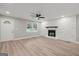 Bright living room with stone fireplace, ceiling fan, hardwood flooring, and neutral gray paint at 438 Punkintown Rd, Villa Rica, GA 30180