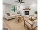 Cozy living room with a decorative fireplace, neutral-toned furniture, and new flooring at 438 Punkintown Rd, Villa Rica, GA 30180