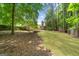 Large backyard with privacy and mature trees offering natural beauty and space at 409 Deergrass Trl, Peachtree City, GA 30269