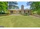 Spacious backyard with lush green grass and mature trees, perfect for outdoor activities at 409 Deergrass Trl, Peachtree City, GA 30269