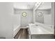 Bright bathroom showcasing tiled floor, vanity, mirror, and a well-maintained shower/tub at 409 Deergrass Trl, Peachtree City, GA 30269