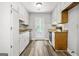 Bright kitchen with white cabinets, granite countertops, and modern stainless steel appliances at 409 Deergrass Trl, Peachtree City, GA 30269