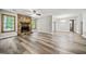 Inviting living room with a stone fireplace, wood-look floors, and ample natural light at 409 Deergrass Trl, Peachtree City, GA 30269