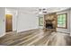 Cozy living room showcasing a stone fireplace, wood-look floors, and bright windows at 409 Deergrass Trl, Peachtree City, GA 30269