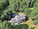 Aerial view of home with pool, featuring a large lot surrounded by lush greenery and mature trees at 437 Mays Rd, Stockbridge, GA 30281