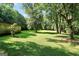 A large, well-manicured backyard features ample green space with mature trees providing shade and privacy at 437 Mays Rd, Stockbridge, GA 30281