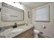 Neutral half bathroom featuring a granite countertop and sleek, modern fixtures at 437 Mays Rd, Stockbridge, GA 30281