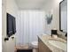 Updated bathroom with granite countertop vanity, and shower with white curtain at 437 Mays Rd, Stockbridge, GA 30281
