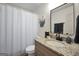 Updated bathroom with granite countertop vanity, and shower with white curtain at 437 Mays Rd, Stockbridge, GA 30281