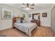 Well-lit bedroom with wood flooring, a ceiling fan, and a large headboard with storage at 437 Mays Rd, Stockbridge, GA 30281
