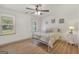 Bright bedroom featuring wood-look flooring, ceiling fan, neutral walls, and ample natural light at 437 Mays Rd, Stockbridge, GA 30281