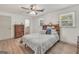 Well-lit bedroom with wood flooring, a ceiling fan, and a large headboard with storage at 437 Mays Rd, Stockbridge, GA 30281