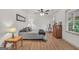 Bright bedroom featuring wood-look flooring, ceiling fan, neutral walls, and ample natural light at 437 Mays Rd, Stockbridge, GA 30281