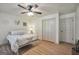 Bright bedroom featuring wood-look flooring, ceiling fan, neutral walls, and closet space at 437 Mays Rd, Stockbridge, GA 30281