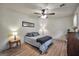 Bright bedroom featuring wood-look flooring, ceiling fan, neutral walls, and ample natural light at 437 Mays Rd, Stockbridge, GA 30281