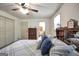 Bedroom with wood flooring, ceiling fan, and bathroom located off of it at 437 Mays Rd, Stockbridge, GA 30281