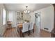 Dining room with wood-look floors, wainscotting, and a classic chandelier above dining table at 437 Mays Rd, Stockbridge, GA 30281