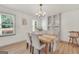 Inviting dining room with natural light showcases a wooden table, plush chairs, and stylish built-in cabinets at 437 Mays Rd, Stockbridge, GA 30281