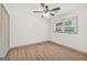 Bright empty room featuring wood-look flooring, ceiling fan, neutral walls, and a big window at 437 Mays Rd, Stockbridge, GA 30281