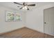 Bright empty room featuring wood-look flooring, ceiling fan, neutral walls, and a big window at 437 Mays Rd, Stockbridge, GA 30281