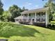 Traditional home features a large yard and covered porch, perfect for enjoying outdoor living at 437 Mays Rd, Stockbridge, GA 30281