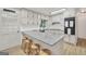 Modern kitchen features white cabinets, granite countertops, stainless steel appliances, and a breakfast bar with stools at 437 Mays Rd, Stockbridge, GA 30281