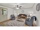 Cozy living room features a ceiling fan, comfortable seating, and a stylish area rug at 437 Mays Rd, Stockbridge, GA 30281