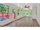 Bright sunroom with ample windows, shiplap walls, and modern ceiling fan at 437 Mays Rd, Stockbridge, GA 30281