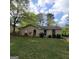 Charming single-story home with a well-maintained lawn and traditional brick facade, set against a backdrop of mature trees at 2884 Haddon Dr, Rex, GA 30273