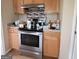 Functional kitchen area with stainless steel appliances, wooden cabinets, and mosaic tile backsplash at 2884 Haddon Dr, Rex, GA 30273