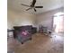 Spacious living room featuring neutral carpet, ceiling fan, and ample natural light from the large arched window at 2884 Haddon Dr, Rex, GA 30273