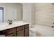 Modern bathroom featuring wood-toned vanity and white tile shower/tub combo at 315 Westfall Ter # 226A, Loganville, GA 30052