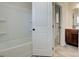 Clean, bright bathroom with a tub, shower, and vanity with wood cabinets at 315 Westfall Ter # 226A, Loganville, GA 30052