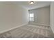 A spacious bedroom with carpet floors and a bright window at 315 Westfall Ter # 226A, Loganville, GA 30052