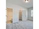 Bedroom with neutral carpet, light walls and bathroom and closet entrances at 315 Westfall Ter # 226A, Loganville, GA 30052
