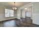 Elegant dining room with classic wainscoting, hardwood floors, and a modern chandelier at 315 Westfall Ter # 226A, Loganville, GA 30052