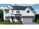 Charming two-story home featuring a white brick exterior, black framed windows, and a gray garage door at 315 Westfall Ter # 226A, Loganville, GA 30052