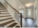 Inviting foyer with hardwood floors and staircase, leading to the home's interior at 315 Westfall Ter # 226A, Loganville, GA 30052