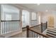 Upstairs hallway with decorative columns, hardwood floors, and views into the adjacent rooms at 315 Westfall Ter # 226A, Loganville, GA 30052