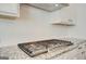 Close up of a gas stovetop and granite countertops in a modern kitchen with subway tile backsplash at 315 Westfall Ter # 226A, Loganville, GA 30052
