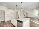 Spacious kitchen featuring a large granite island, stainless steel appliances and seamless transition to the living room at 315 Westfall Ter # 226A, Loganville, GA 30052