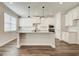 Bright kitchen with white cabinets, granite countertops, stainless steel appliances, and a large island at 315 Westfall Ter # 226A, Loganville, GA 30052