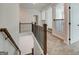 Upstairs landing featuring wood and iron railing with carpeted floors at 315 Westfall Ter # 226A, Loganville, GA 30052