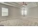 Spacious primary bedroom with tray ceilings, ceiling fan, and bright windows at 315 Westfall Ter # 226A, Loganville, GA 30052