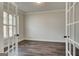 Office space with hardwood floors, neutral paint, and glass French doors at 315 Westfall Ter # 226A, Loganville, GA 30052