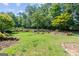 Spacious backyard with mature trees, terraced landscaping, and a well-maintained lawn at 3498 Overland Trl, Ellenwood, GA 30294